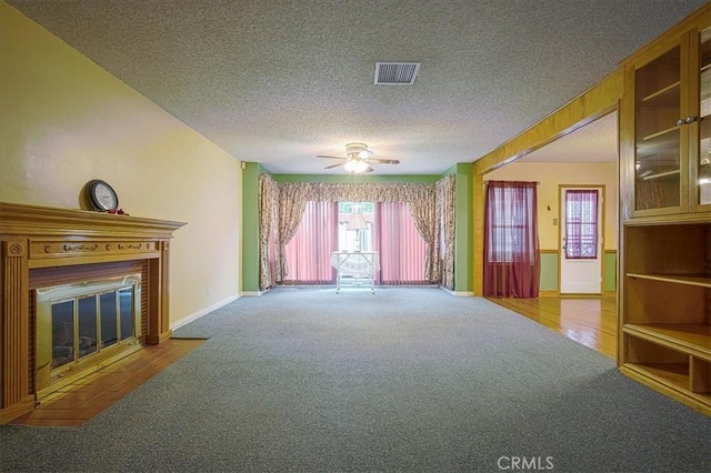 5062 Magnolia Ave, Riverside, CA 92506 - unfurnished living room with carpet flooring, a textured ceiling, a fireplace with flush hearth, ceiling fan, and baseboards