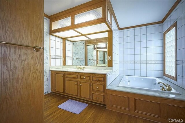 5062 Magnolia Ave, Riverside, CA 92506 - full bath featuring wood finished floors, a tub with jets, vanity, and ornamental molding