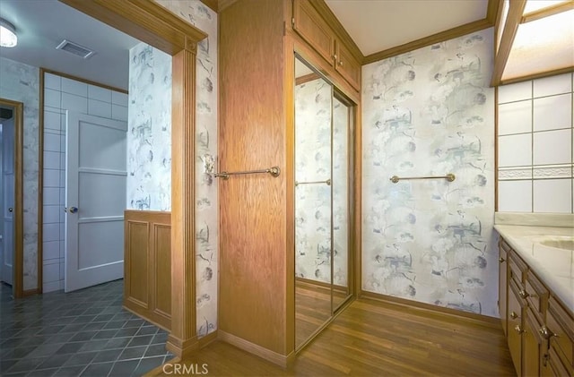 5062 Magnolia Ave, Riverside, CA 92506 - bathroom featuring wallpapered walls, vanity, wood finished floors, and baseboards