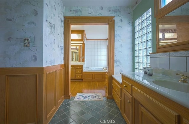 5062 Magnolia Ave, Riverside, CA 92506 - full bathroom featuring wallpapered walls, vanity, a garden tub, and wood finished floors