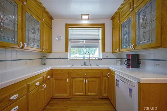 5062 Magnolia Ave, Riverside, CA 92506 - kitchen with dishwasher, a sink, glass insert cabinets, and light wood finished floors