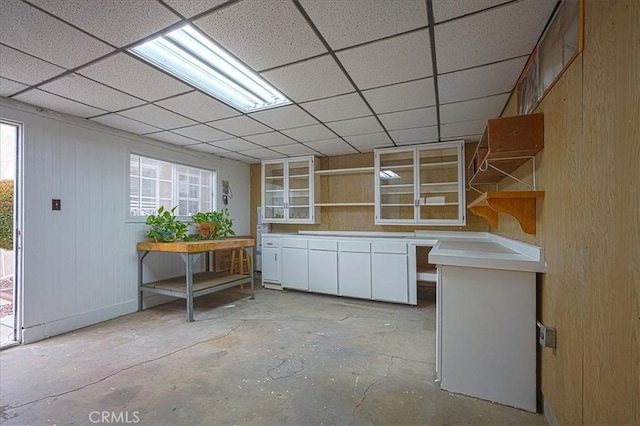 5062 Magnolia Ave, Riverside, CA 92506 - kitchen featuring open shelves, white cabinets, concrete floors, light countertops, and a paneled ceiling