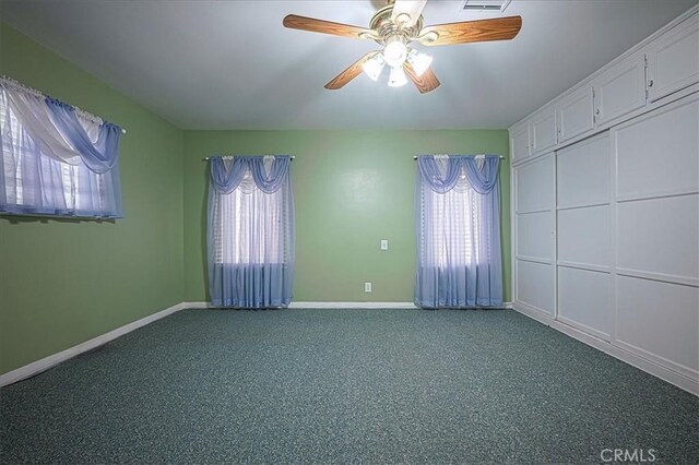 5062 Magnolia Ave, Riverside, CA 92506 - spare room featuring plenty of natural light, baseboards, dark carpet, and a ceiling fan