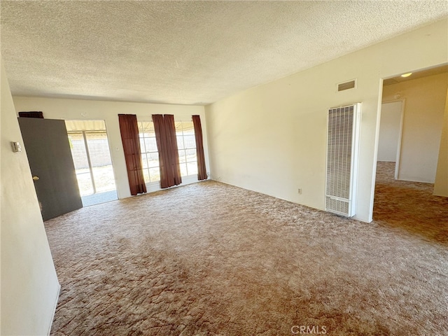 2574 W Glencrest Ave, Anaheim, CA 92801 - carpeted spare room featuring a heating unit and a textured ceiling