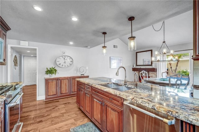 631 Holmes Ave, Placentia, CA 92870 - kitchen featuring a sink, stainless steel appliances, light wood-style flooring, lofted ceiling, and decorative light fixtures
