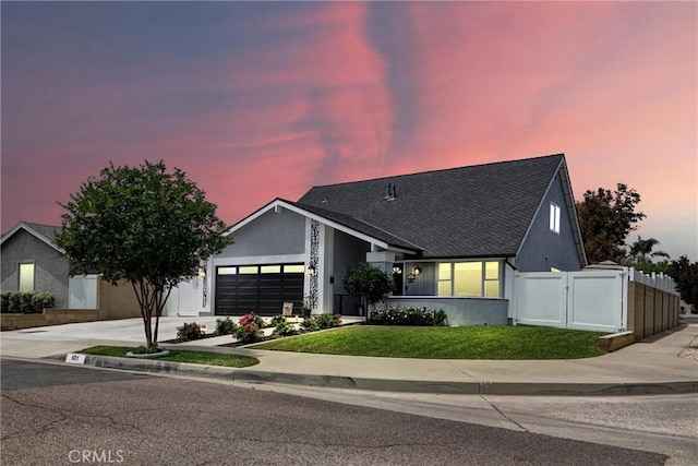 631 Holmes Ave, Placentia, CA 92870 - view of front of house with stucco siding, an attached garage, driveway, a shingled roof, and a gate