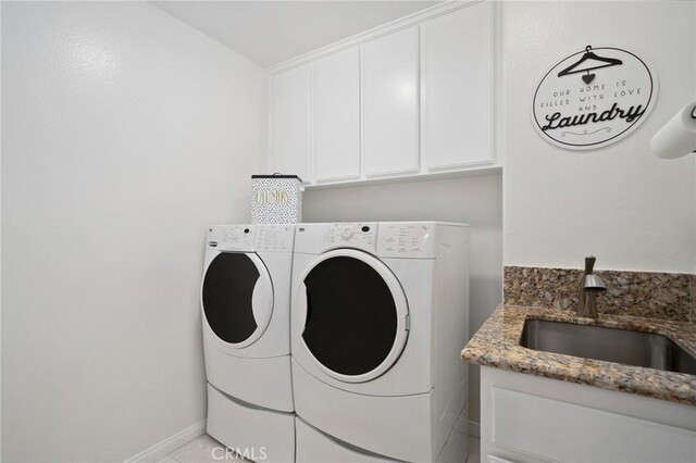 4583 Tuscani Dr, Cypress, CA 90630 - laundry area featuring washing machine and dryer, cabinet space, and baseboards