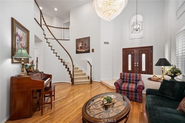 4583 Tuscani Dr, Cypress, CA 90630 - entryway featuring a chandelier, a high ceiling, stairway, wood finished floors, and recessed lighting