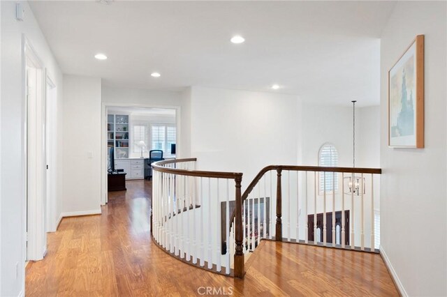 4583 Tuscani Dr, Cypress, CA 90630 - hall with wood finished floors, an upstairs landing, recessed lighting, baseboards, and a chandelier