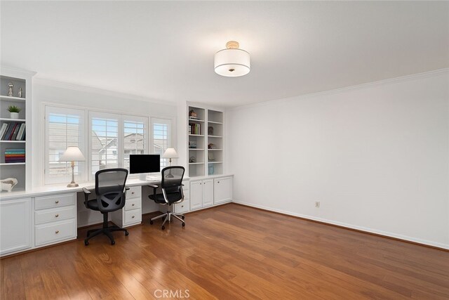 4583 Tuscani Dr, Cypress, CA 90630 - office area featuring wood finished floors, ornamental molding, built in shelves, built in desk, and baseboards