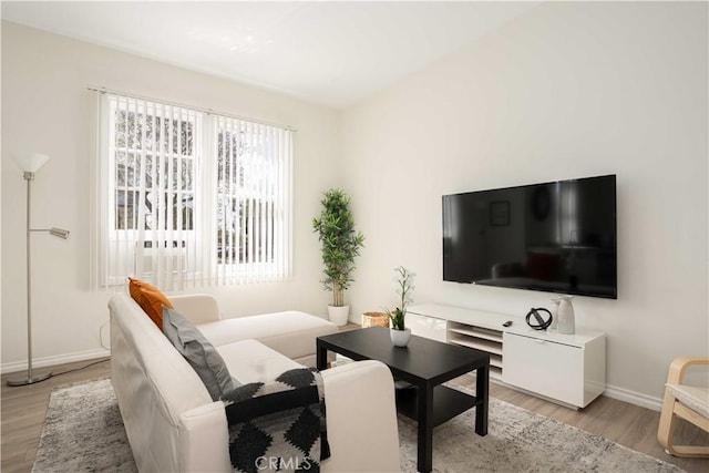 1168 W 35th St, Los Angeles, CA 90007 - living room featuring baseboards and light wood-type flooring