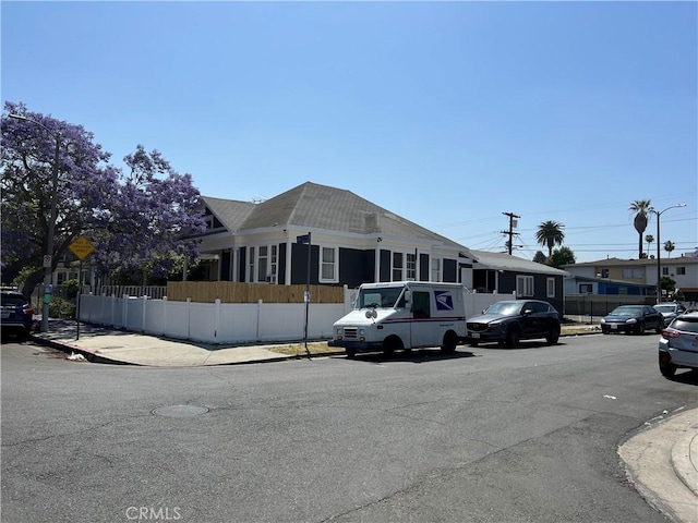 1168 W 35th St, Los Angeles, CA 90007 - view of asphalt street with sidewalks, curbs, traffic signs, and street lights