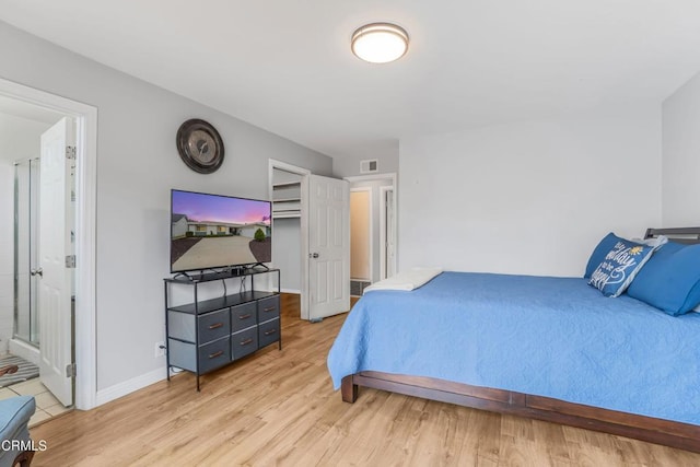 1215 Lawrence Way, Oxnard, CA 93035 - bedroom with light wood-style flooring, baseboards, a walk in closet, and ensuite bath