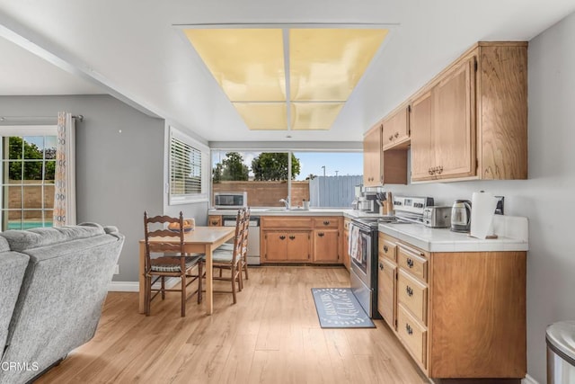 1215 Lawrence Way, Oxnard, CA 93035 - kitchen with appliances with stainless steel finishes, light wood-style floors, light countertops, and healthy amount of natural light