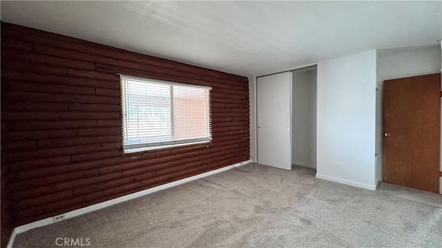 11213 Monte Vista Rd, Phelan, CA 92371 - unfurnished room with light carpet, rustic walls, and baseboards