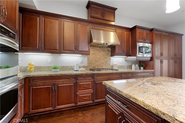 1138 Las Colinas Way, San Dimas, CA 91773 - kitchen with extractor fan, appliances with stainless steel finishes, dark wood finished floors, light stone countertops, and decorative backsplash