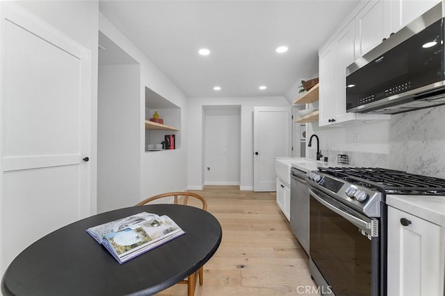 4312 Division St, Los Angeles, CA 90065 - kitchen with stainless steel appliances, open shelves, white cabinetry, decorative backsplash, and recessed lighting