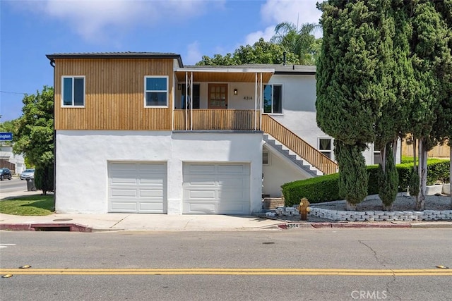 4312 Division St, Los Angeles, CA 90065 - contemporary house with driveway, stairs, an attached garage, and stucco siding