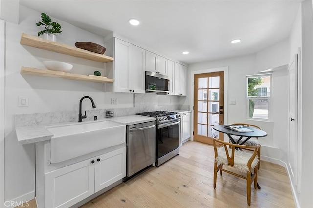 4312 Division St, Los Angeles, CA 90065 - kitchen with appliances with stainless steel finishes, a sink, open shelves, light wood finished floors, and recessed lighting