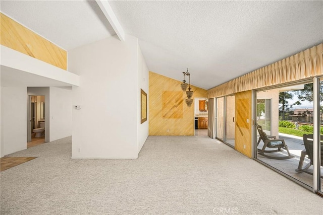 6459 E Via Arboles, Anaheim Hills, CA 92807 - unfurnished living room featuring wood walls, carpet floors, and a textured ceiling