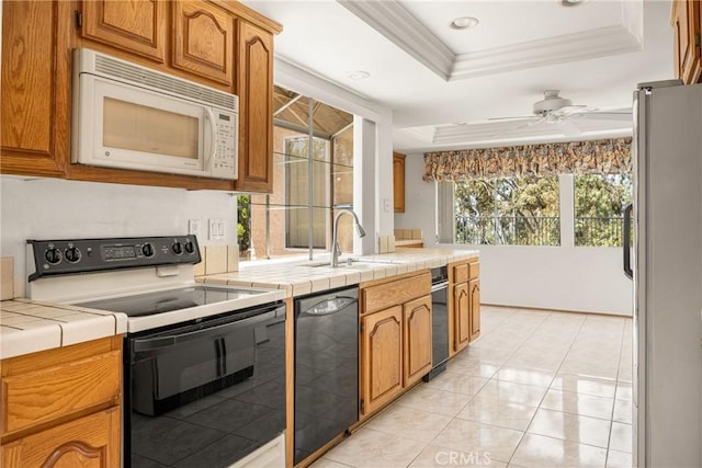 6459 E Via Arboles, Anaheim Hills, CA 92807 - kitchen with white microwave, range with electric stovetop, freestanding refrigerator, a sink, and a tray ceiling
