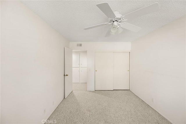 6459 E Via Arboles, Anaheim Hills, CA 92807 - unfurnished bedroom with a textured ceiling, light colored carpet, a closet, and a ceiling fan