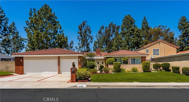 6459 E Via Arboles, Anaheim Hills, CA 92807 - view of front facade with a tile roof, a front lawn, a chimney, driveway, and an attached garage
