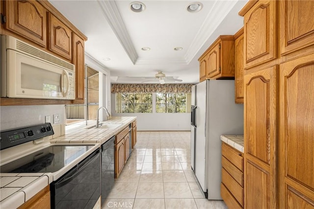 6459 E Via Arboles, Anaheim Hills, CA 92807 - kitchen featuring white appliances, tile countertops, a sink, a raised ceiling, and crown molding