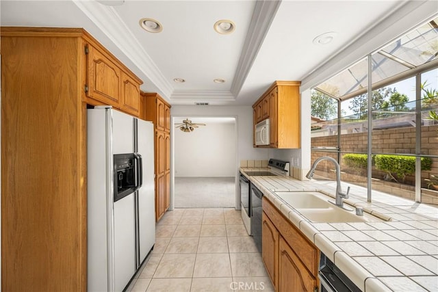 6459 E Via Arboles, Anaheim Hills, CA 92807 - kitchen with white appliances, tile counters, a sink, light colored carpet, and ceiling fan