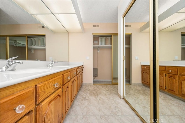 6459 E Via Arboles, Anaheim Hills, CA 92807 - bathroom with double vanity, a walk in closet, and tile patterned floors