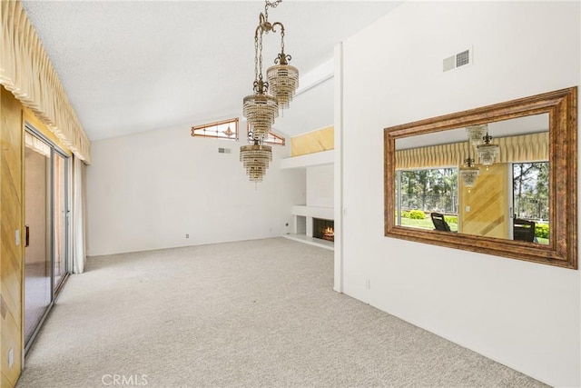 6459 E Via Arboles, Anaheim Hills, CA 92807 - unfurnished living room with light carpet, a warm lit fireplace, a chandelier, and high vaulted ceiling