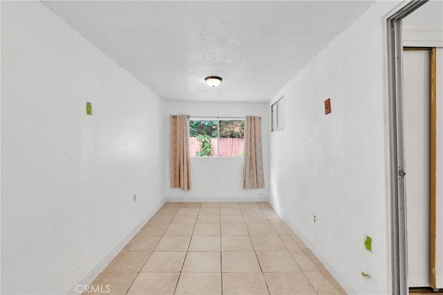 470 E Home St, Long Beach, CA 90805 - unfurnished room with a textured ceiling, baseboards, and light tile patterned floors