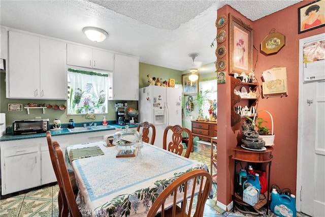 470 E Home St, Long Beach, CA 90805 - kitchen with white fridge with ice dispenser, a textured ceiling, white cabinetry, and a sink