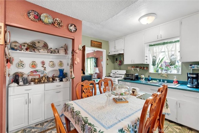 470 E Home St, Long Beach, CA 90805 - kitchen featuring gas range gas stove, a sink, a textured ceiling, under cabinet range hood, and white cabinetry