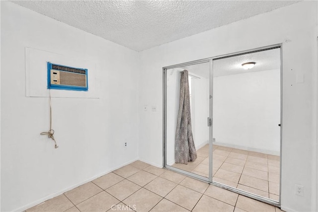 470 E Home St, Long Beach, CA 90805 - unfurnished bedroom with a textured ceiling, light tile patterned floors, a wall unit AC, baseboards, and a closet