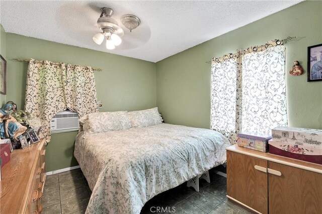 470 E Home St, Long Beach, CA 90805 - bedroom with dark tile patterned flooring, a ceiling fan, a textured ceiling, and baseboards