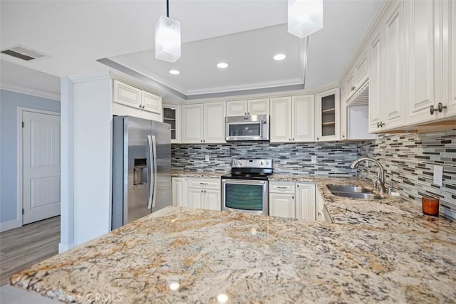 4014 Calle Sonora Oeste Unit 1G, Laguna Woods, CA 92637 - kitchen featuring appliances with stainless steel finishes, ornamental molding, a sink, light wood-type flooring, and backsplash