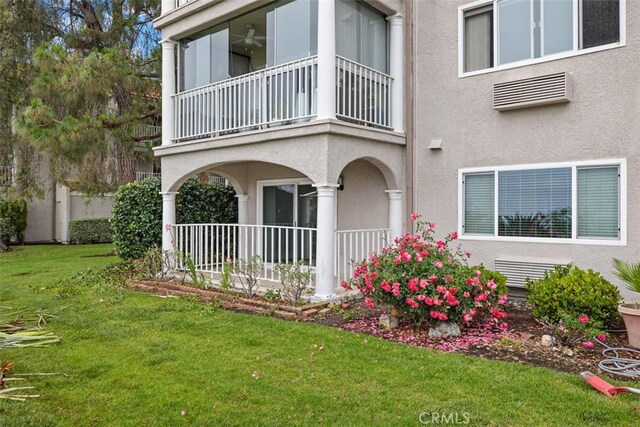 4014 Calle Sonora Oeste Unit 1G, Laguna Woods, CA 92637 - view of side of home with a balcony, stucco siding, a lawn, and covered porch