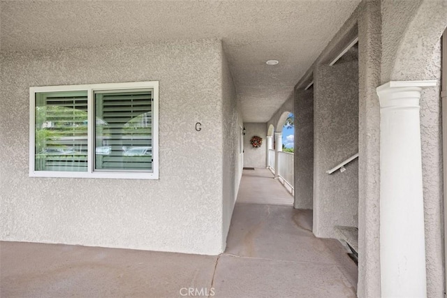 4014 Calle Sonora Oeste Unit 1G, Laguna Woods, CA 92637 - property entrance with stucco siding and a balcony
