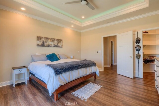 2381 Clearview Dr, Paradise, CA 95969 - bedroom with a tray ceiling, ornamental molding, a walk in closet, wood finished floors, and baseboards