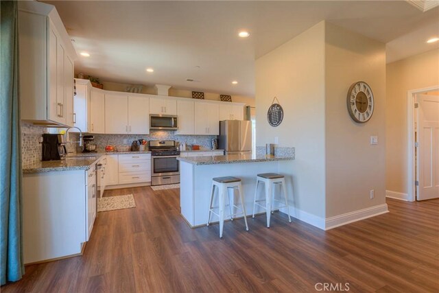 2381 Clearview Dr, Paradise, CA 95969 - kitchen with appliances with stainless steel finishes, a sink, light stone countertops, a peninsula, and recessed lighting