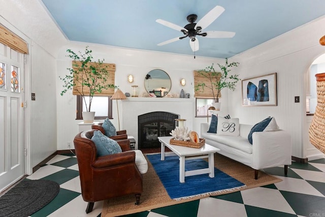 1008 S Ditmar St, Oceanside, CA 92054 - living room featuring tile patterned floors, a glass covered fireplace, arched walkways, and ceiling fan