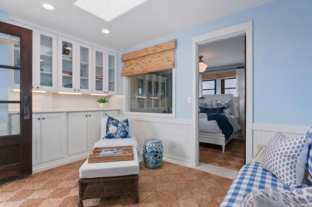 1008 S Ditmar St, Oceanside, CA 92054 - living area with light colored carpet, a skylight, wainscoting, and recessed lighting