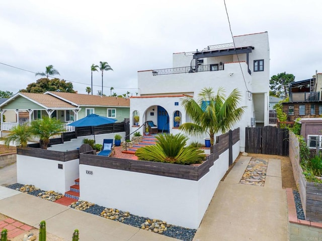 1008 S Ditmar St, Oceanside, CA 92054 - mediterranean / spanish home with a fenced front yard, a balcony, a gate, and stucco siding