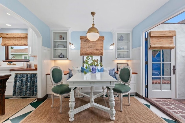 1008 S Ditmar St, Oceanside, CA 92054 - dining room with a wainscoted wall, arched walkways, and built in features