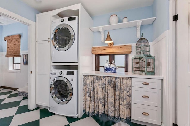1008 S Ditmar St, Oceanside, CA 92054 - laundry area featuring stacked washer / drying machine, cabinet space, and tile patterned floors