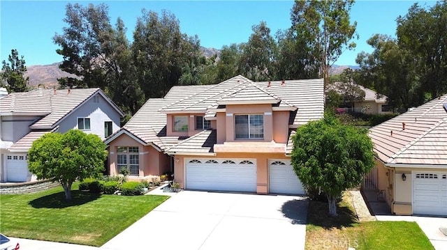 29058 Rosewood Ln, Highland, CA 92346 - view of front of property featuring stucco siding, concrete driveway, a garage, a front lawn, and a tile roof