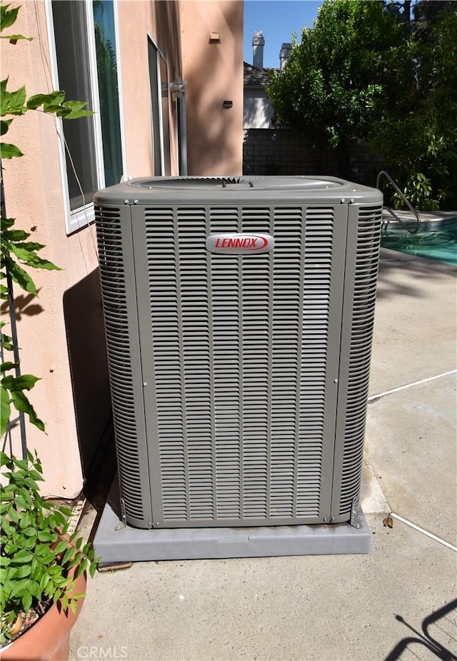 29058 Rosewood Ln, Highland, CA 92346 - exterior view of cooling unit, stucco siding, and a swimming pool
