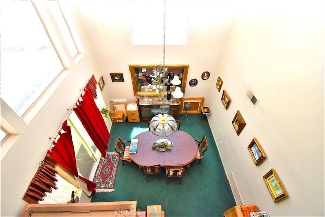 29058 Rosewood Ln, Highland, CA 92346 - carpeted dining area with a towering ceiling and a chandelier