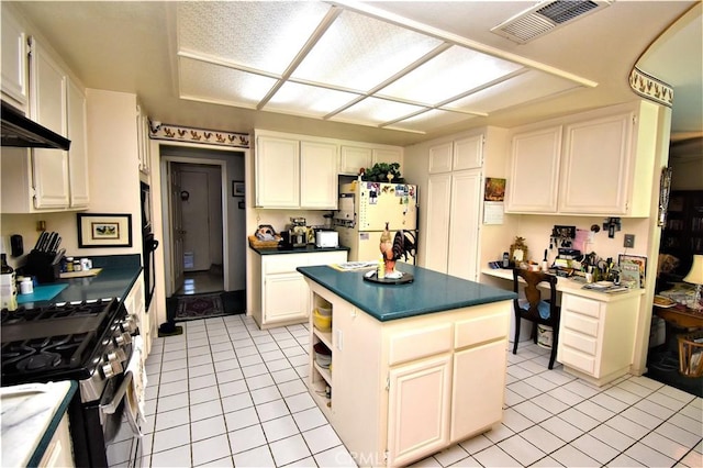 29058 Rosewood Ln, Highland, CA 92346 - kitchen with freestanding refrigerator, gas stove, dark countertops, and light tile patterned floors